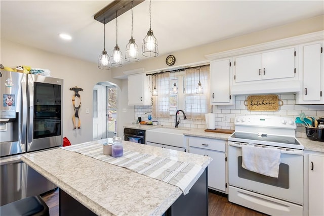 5 Beach St, Centerville, PA 15358 - kitchen with white electric range oven, stainless steel refrigerator with ice dispenser, custom exhaust hood, arched walkways, and light countertops