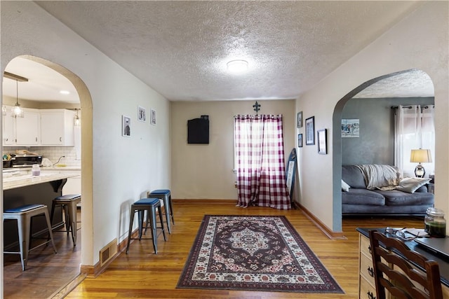 5 Beach St, Centerville, PA 15358 - entrance foyer with arched walkways, light wood-type flooring, a textured ceiling, and baseboards