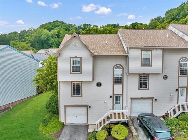 309 Wildflower Ct, Ross Twp, PA 15202 - view of front of home with an attached garage, driveway, a shingled roof, and a front yard