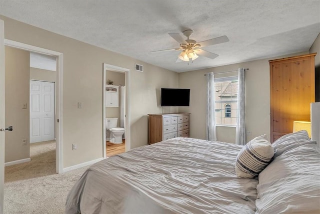 309 Wildflower Ct, Ross Twp, PA 15202 - carpeted bedroom with baseboards, ensuite bathroom, ceiling fan, and a textured ceiling