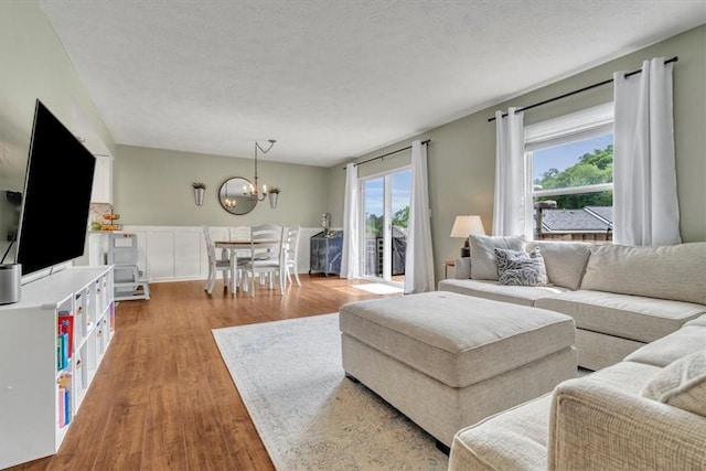 309 Wildflower Ct, Ross Twp, PA 15202 - living room with wood finished floors and a chandelier