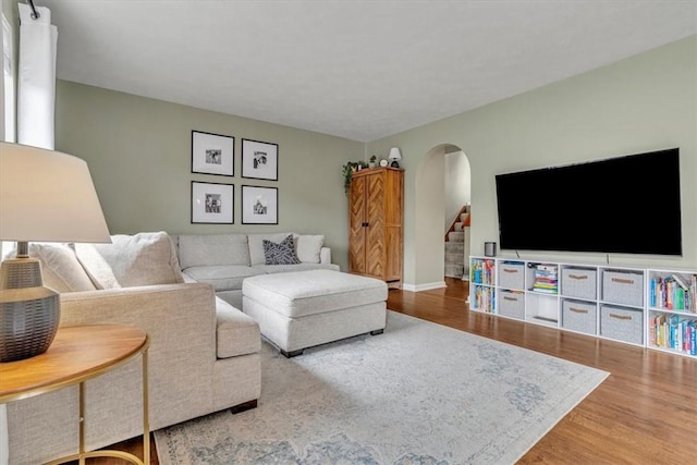 309 Wildflower Ct, Ross Twp, PA 15202 - living area featuring arched walkways, wood finished floors, stairs, and baseboards