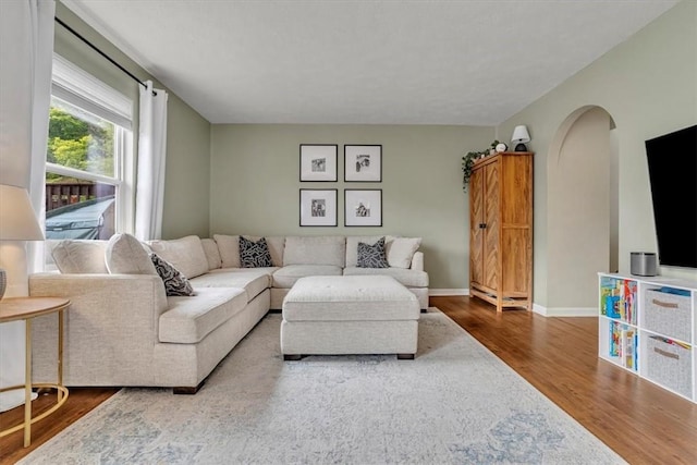 309 Wildflower Ct, Ross Twp, PA 15202 - living area featuring wood finished floors, arched walkways, and baseboards