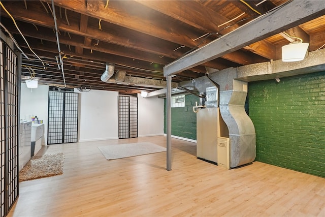 1122 Tyndall St, Sheraden, PA 15204 - below grade area featuring wood finished floors, brick wall, and baseboards