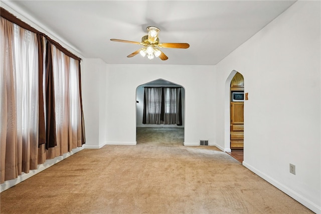 1122 Tyndall St, Sheraden, PA 15204 - carpeted spare room with arched walkways, a ceiling fan, and baseboards