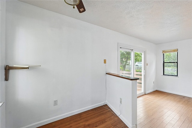 1122 Tyndall St, Sheraden, PA 15204 - spare room with wood finished floors, a textured ceiling, baseboards, and a ceiling fan