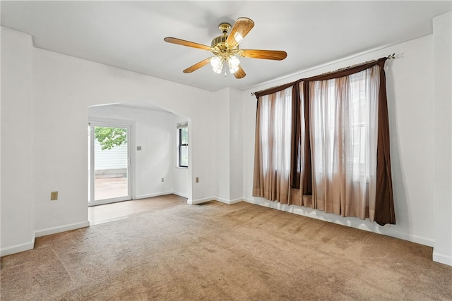 1122 Tyndall St, Sheraden, PA 15204 - empty room with arched walkways, carpet floors, a ceiling fan, and baseboards