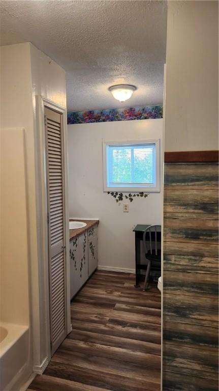 1737 Perry Hwy, Volant, PA 16156 - full bath with a textured ceiling, wood finished floors, a bath, and baseboards