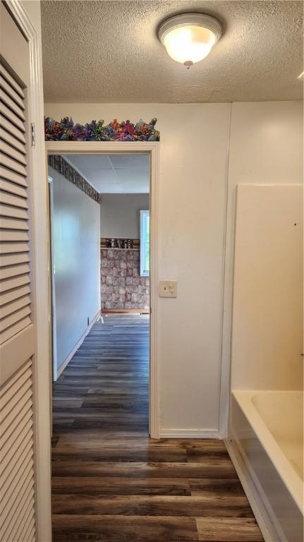 1737 Perry Hwy, Volant, PA 16156 - corridor with dark wood-type flooring and a textured ceiling