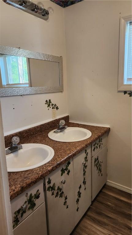 1737 Perry Hwy, Volant, PA 16156 - bathroom with double vanity, wood finished floors, and baseboards