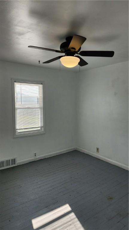 1737 Perry Hwy, Volant, PA 16156 - unfurnished room featuring baseboards, dark wood-type flooring, and ceiling fan