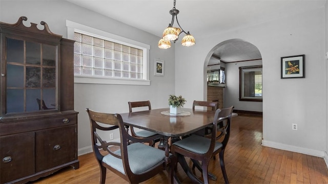 2536 Middletown Rd, Crafton Heights, PA 15205 - dining space with arched walkways, baseboards, and light wood-style flooring