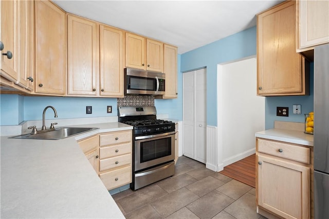 1313 Virginia Ave, Mt Washington, PA 15211 - kitchen featuring light brown cabinetry, stainless steel appliances, a sink, and light countertops