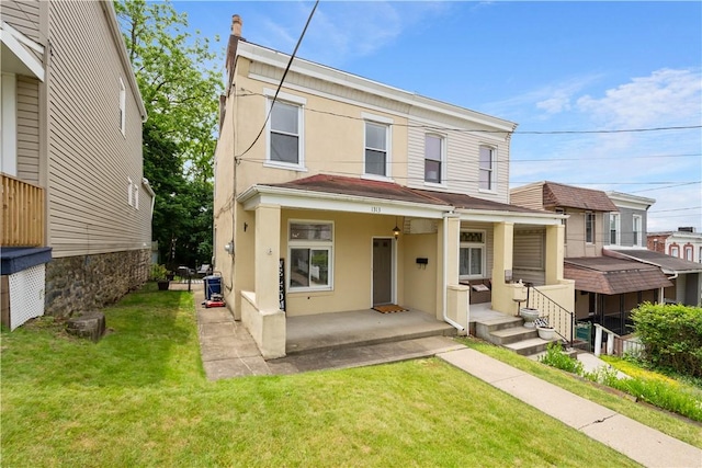 1313 Virginia Ave, Mt Washington, PA 15211 - view of front of house with stucco siding, a front yard, and covered porch