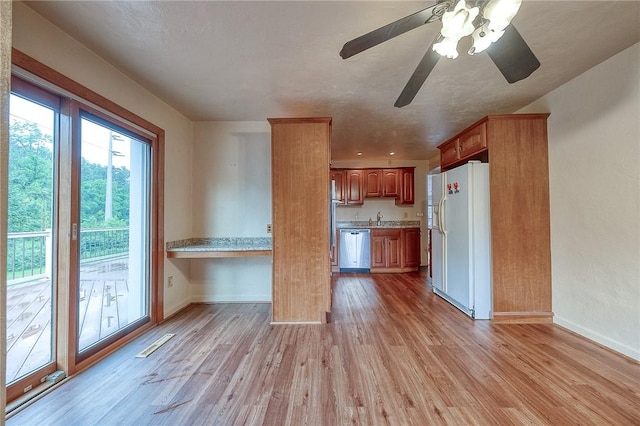 3333 Walther Ln, Upper St Clair, PA 15241 - kitchen featuring white refrigerator with ice dispenser, stainless steel dishwasher, light countertops, baseboards, and light wood finished floors