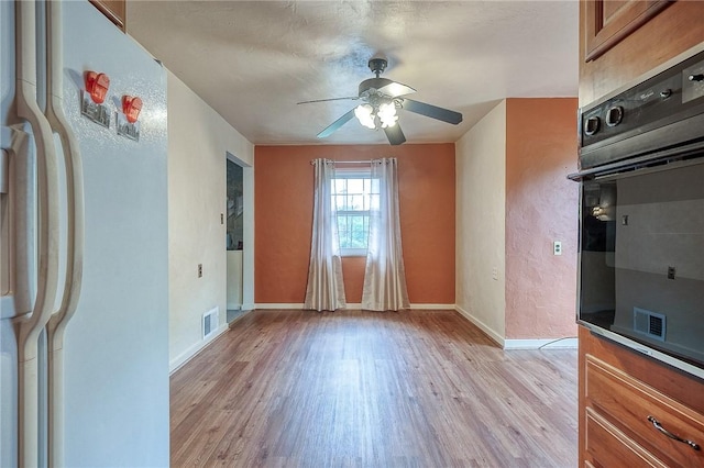 3333 Walther Ln, Upper St Clair, PA 15241 - unfurnished dining area with light wood finished floors, ceiling fan, and baseboards