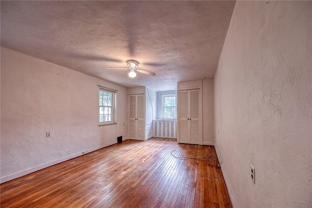 3333 Walther Ln, Upper St Clair, PA 15241 - unfurnished room with hardwood / wood-style floors, ceiling fan, baseboards, a textured wall, and a textured ceiling