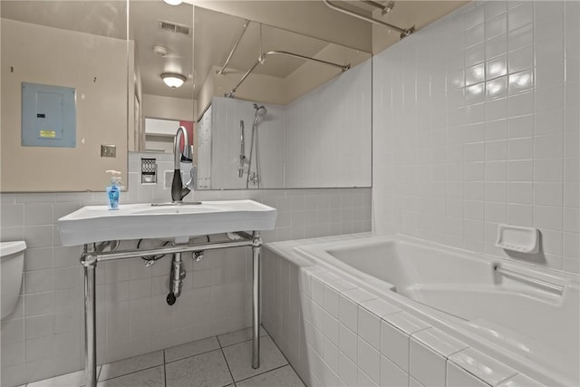 2811 Leona Ln, Robinson Twp Nwa, PA 15108 - bathroom featuring electric panel, tile walls, tile patterned flooring, tiled shower / bath, and toilet