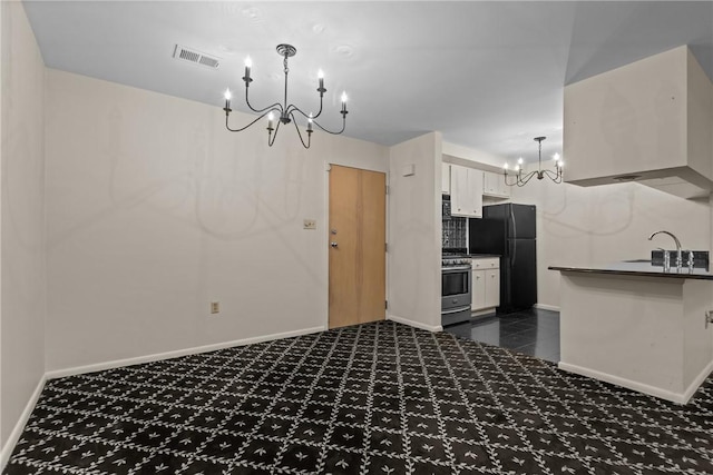 2811 Leona Ln, Robinson Twp Nwa, PA 15108 - kitchen featuring a chandelier, freestanding refrigerator, a sink, dark carpet, and stainless steel range with gas stovetop