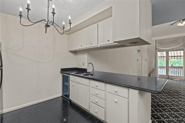 2811 Leona Ln, Robinson Twp Nwa, PA 15108 - kitchen with a sink, white cabinetry, baseboards, and a peninsula