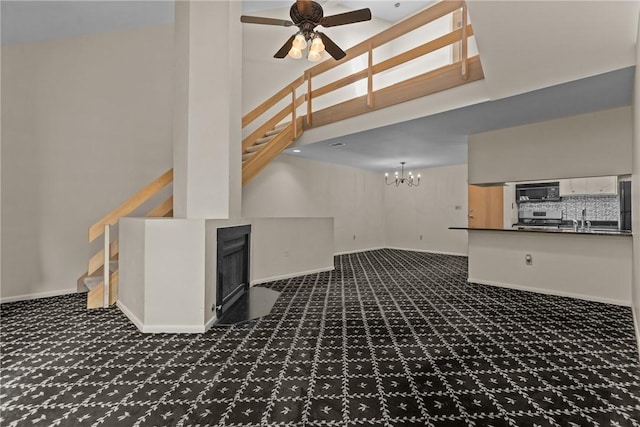 2811 Leona Ln, Robinson Twp Nwa, PA 15108 - unfurnished living room with carpet, stairs, a ceiling fan, a chandelier, and a high ceiling