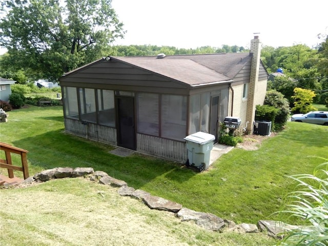 204 Stonebrook Dr, Peters Twp, PA 15317 - view of side of property featuring a sunroom, cooling unit, a yard, and a chimney