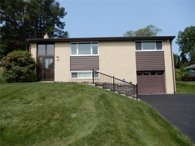 204 Stonebrook Dr, Peters Twp, PA 15317 - back of property with driveway, an attached garage, brick siding, a yard, and a chimney