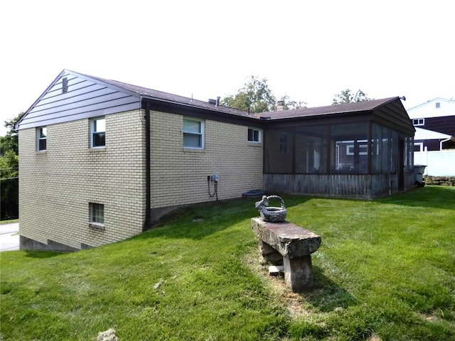 204 Stonebrook Dr, Peters Twp, PA 15317 - view of side of home featuring a sunroom, a yard, and brick siding