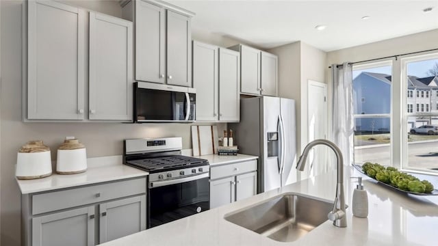 699 Olivia St, Collier Twp, PA 15205 - kitchen with stainless steel appliances, a sink, light countertops, and gray cabinetry