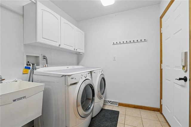807 Rembrandt Cir, Hempfield Twp Wml, PA 15642 - laundry area featuring cabinet space, washer and clothes dryer, baseboards, and light tile patterned flooring