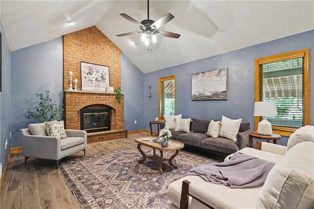 807 Rembrandt Cir, Hempfield Twp Wml, PA 15642 - living room with wood finished floors, vaulted ceiling, ceiling fan, a brick fireplace, and baseboards