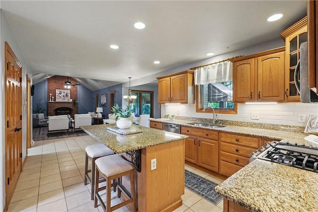 807 Rembrandt Cir, Hempfield Twp Wml, PA 15642 - kitchen with a sink, a center island, a brick fireplace, light stone counters, and lofted ceiling