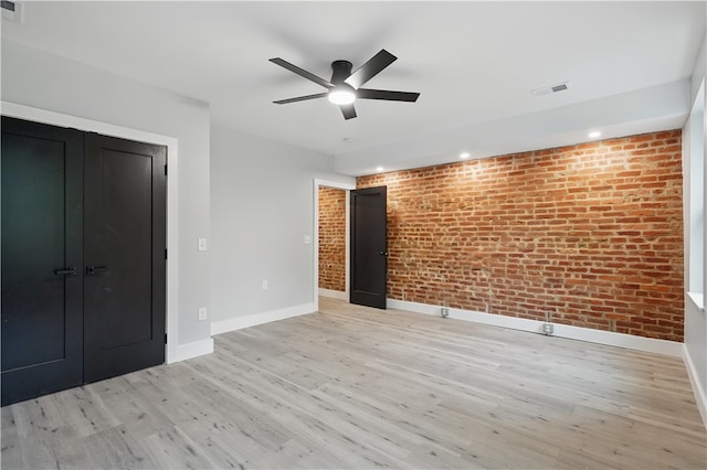 346 45th St, Lawrenceville, PA 15201 - unfurnished bedroom featuring brick wall, baseboards, light wood-style flooring, a ceiling fan, and a closet