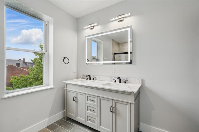 346 45th St, Lawrenceville, PA 15201 - bathroom with baseboards, double vanity, and plenty of natural light