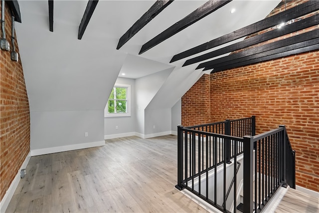 346 45th St, Lawrenceville, PA 15201 - additional living space featuring brick wall, baseboards, and wood finished floors
