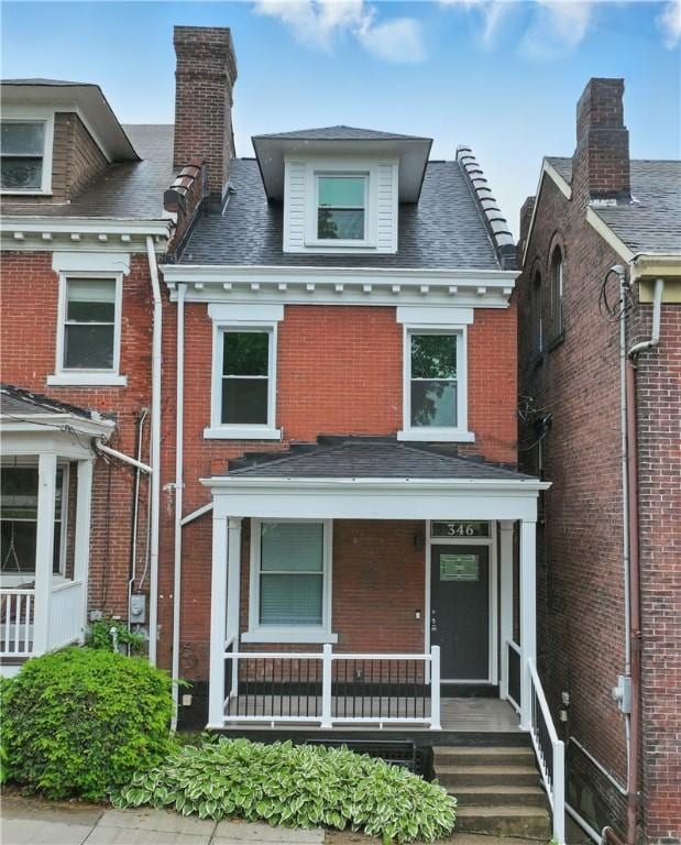 346 45th St, Lawrenceville, PA 15201 - view of front of property featuring brick siding, covered porch, and a chimney
