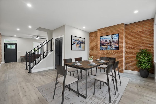 346 45th St, Lawrenceville, PA 15201 - dining space featuring baseboards, light wood-style flooring, stairway, recessed lighting, and brick wall