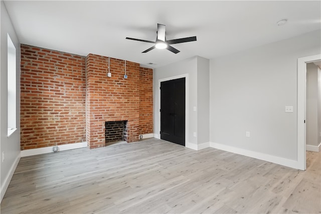 346 45th St, Lawrenceville, PA 15201 - unfurnished living room featuring a ceiling fan, wood finished floors, baseboards, and a fireplace