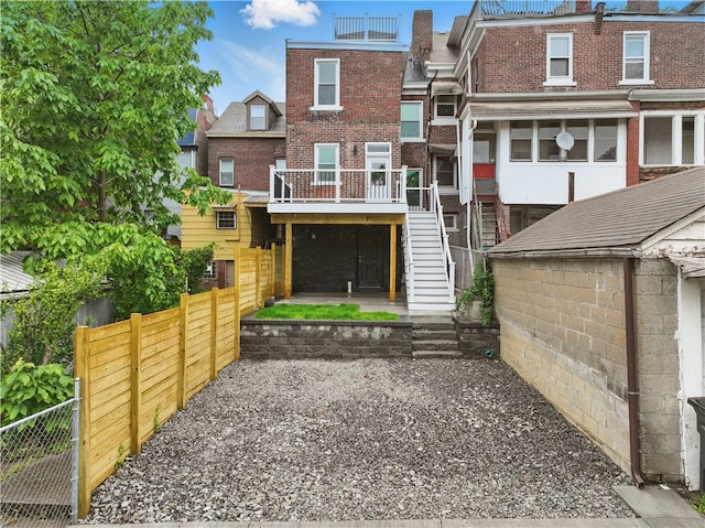 346 45th St, Lawrenceville, PA 15201 - view of front facade with stairway, brick siding, and a wooden deck