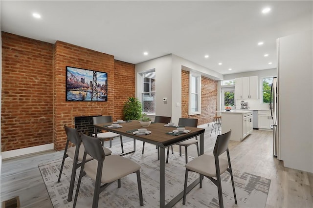 346 45th St, Lawrenceville, PA 15201 - dining space with light wood-style flooring, baseboards, brick wall, and recessed lighting