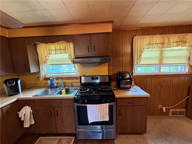 201 Lebanon Manor Dr, West Mifflin, PA 15122 - kitchen with gas stove, a sink, under cabinet range hood, light countertops, and plenty of natural light