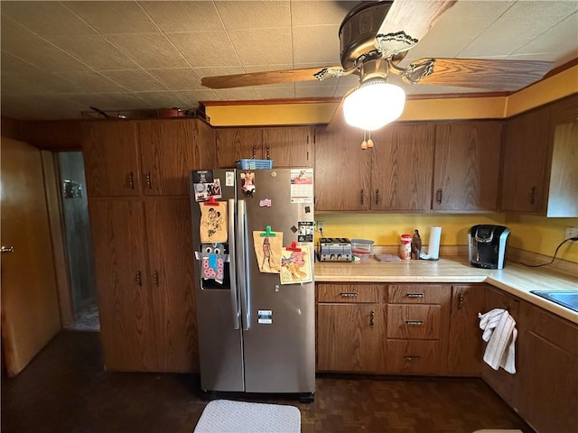 201 Lebanon Manor Dr, West Mifflin, PA 15122 - kitchen featuring freestanding refrigerator, light countertops, brown cabinetry, and a ceiling fan