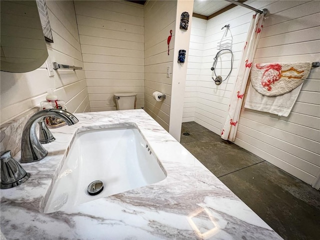 126 Dockside Ln, Bradys Bend Twp, PA 16028 - bathroom featuring a sink, concrete flooring, and wood walls