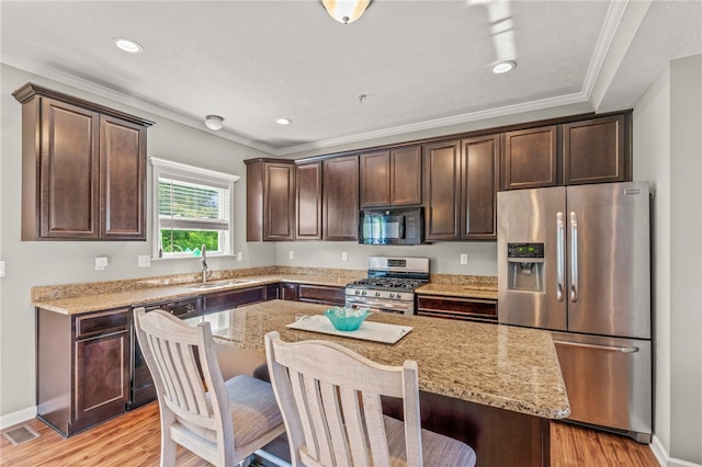 210 Brae Glen Dr, North Strabane, PA 15317 - kitchen with appliances with stainless steel finishes, a sink, dark brown cabinets, light stone counters, and ornamental molding