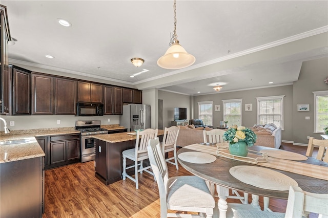 210 Brae Glen Dr, North Strabane, PA 15317 - kitchen featuring stainless steel appliances, a sink, dark brown cabinets, open floor plan, and a kitchen island