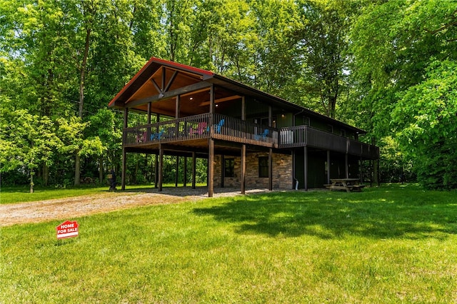 7832 Chase Dr, Shenango-Cra, PA 16134 - back of house featuring dirt driveway, stone siding, a deck, and a lawn