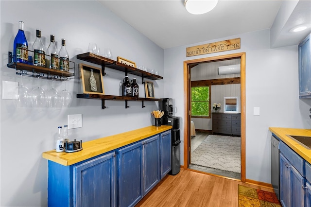 7832 Chase Dr, Shenango-Cra, PA 16134 - indoor dry bar with dishwasher, light wood-style flooring, a wall mounted air conditioner, and baseboards