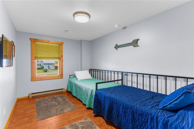 7832 Chase Dr, Shenango-Cra, PA 16134 - bedroom with a baseboard radiator, wood finished floors, and baseboards