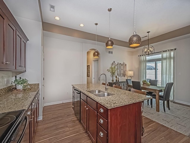 138 Cobblestone, Ohio Twp, PA 15237 - kitchen featuring stainless steel dishwasher, a sink, arched walkways, dark wood-style flooring, and recessed lighting