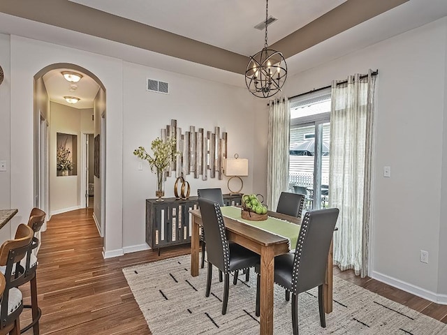 138 Cobblestone, Ohio Twp, PA 15237 - dining area featuring arched walkways, wood finished floors, a chandelier, and baseboards